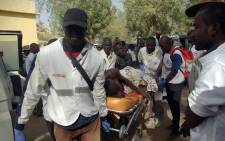 FILE: A wounded person is carried on a stretcher in Mora, following suicide attacks in the border city of Kerawa, northern Cameroon. Picture: AFP