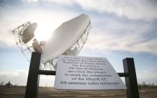 One of the 64 radio telescopes that are part of the MeerKAT project behind a plaque unveiled by Deputy President David Mabuza. Picture: Bertram Malgas/EWN