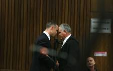 Oscar Pistorius consults with his defence lawyer Barry Roux at the High Court in Pretoria on 6 May 2014. Picture: Pool.
