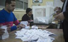 Polling station officials count ballots in the Egyptian capital Cairo on 15 January 2014 at the end of the second day of voting in a referendum on a new constitution. Picture: AFP.