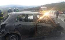Two vehicles, a taxi and a car, involved in a head-on collision near Sir Lowry’s Pass have burnt out. Picture: Western Cape Traffic.