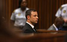 Paralympian Oscar Pistorius is seen during judgment in his murder trial at the High Court in Pretoria on Friday, 12 September 2014. Picture: Pool.