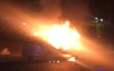 A screengrab shows a car torched during clashes between Uber and meter taxi drivers on 7 September 2017. Picture: EWN