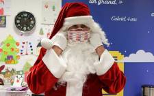 A man dressed as Santa Claus puts a face mask on at the Libourne's post office, southwestern France, on 10 December 2020. Picture: AFP