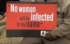 A poster held by one of the men attending the national men's rally against women and child abuse at the Johannesburg stadium on 24 August 2013. Picture: Reinart Toerien/EWN