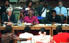 FILE: Then Archbishop Desmond Tutu (centre) with fellow commissioners listen to testimony from witnesses during the start of the Truth and Reconciliation Commission which opened in East London, 15 April 1996. Picture: AFP.