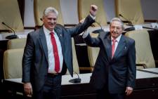 Outgoing Cuban President Raul Castro (R) raises the arm of Cuba’s new President Miguel Diaz-Canel after he was formally named by the National Assembly, in Havana on 19 April 2018. Picture: AFP.