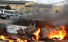 A car burns on 16 November 2013 in the central port city of Beira during clashes between riot police and locals at the last stage of campaigning for the 20 November municipal elections. Picture: AFP