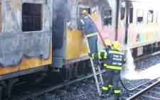 FILE: Firefighters trying to extinguish fire on a Metrorail train in Woodstock on 22 January 2013. Picture: Supplied