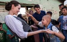 This handout picture released by the UNHCR, shows Special Envoy Angelina Jolie meeting Falak, 8, during a visit to West Mosul, on June 16, 2018. Picture: AFP.