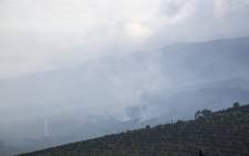 Smoke rises from the hillsides of the Constantia valley after the March 2015 fire swept through the area around the Groot Constantia wine estate. Picture: Aletta Gardner/EWN