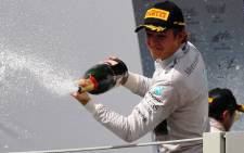 German driver Nico Rosberg, of Mercedes, celebrates his first place on the podium after the Brazilian Formula One Grand Prix in the Interlagos race track in Sao Paulo, Brazil, 9 November 2014 Picture: EPA.