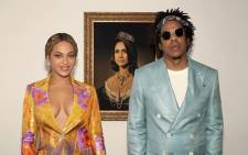 Beyoncé and Jay-Z stand in front of a portrait of the Duchess of Sussex, Meghan Markle. Picture: @beyonce/instagram.com