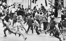 This file photo taken on October 1976 shows demonstrators running away from a police charge during racial riots, in Cape Town. Picture: AFP.