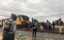 FILE: Commuters outside a train in Philippi after a man was electrocuted, prompting delays in Metrorail train services in the area. Picture: Kaylynn Palm/EWN