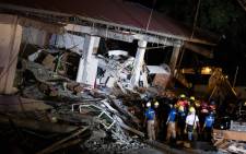 Rescue workers search for survivors in a collapsed Chuzon Super Market in Porac, Pampanga, after a powerful earthquake hit the northern Philippines on 22 April 2019. Picture: AFP.
