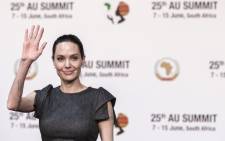 US actress and UNHCR representative Angelina Jolie waves ahead of a panel on conflict-related gender violence on 12 June 2015 during a session of the African Union Summit in Johannesburg. Picture: AFP.