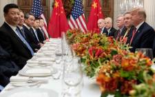US President Donald Trump (R) and China's President Xi Jinping (L) along with members of their delegations, hold a dinner meeting at the end of the G20 Leaders' Summit in Buenos Aires, on 1 December 2018. Picture: AFP