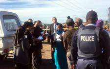 Officials are pictured on scene where an inspection was conducted in Khayelitsha where the body of Sinoxolo Mafevuka was found. Picture: Kevin Brandt/EWN.