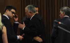 FILE: Oscar Pistorius is greeted by his lawyer Barry Roux. Picture: Pool.