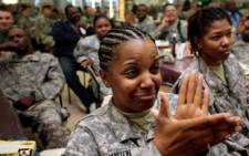 US Army Staff Sgt. Beverlee Burton of Cleveland, Ohio cries while sitting next to Capt. Adhana McCarthy (R) as they watch Barack Obama sworn in as the 44th President of the United States of America on January 20, 2009. Picture: Gallo Images/Getty Images