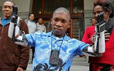 Flippie Engelbrecht is seen with his parents Flip and Katrina after he received prosthetic hands in Cape Town on 16 August 2013. Picture: Sapa"