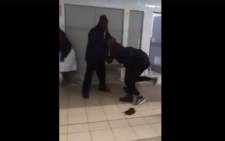 A screengrab of Tlotlo Ntehelang being pulled away by security guards at the Mamelodi Day Hospital.