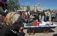People mourn during the funeral ceremony for a pro-Russian activist killed during combat with Ukrainian troops in Kramatorsk, eastern Ukraine, on 6 May 2014. Picture: AFP.