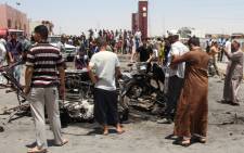 FILE: Iraqi's inspect the site of a suicide bomb attack. Picture: AFP
