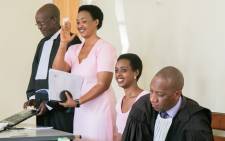 Diane Rwigara (2nd R), a prominent critic of Rwanda's president, and her mother Adeline Rwigara (2nd L), react after their trial was postponed on 24 September 2018, at the hight court of Rwanda in Kigali. Picture: AFP.
