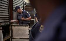 Members of the South African Police Services raiding one of the shops in Johannesburg CBD on 6 August 2019.Picture: Sethembiso Zulu/EWN 