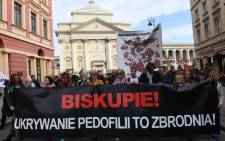 FILE: Protesters hold a banner reading "Bishop, Hiding Pedophilia is a Crime" and a map reading "Map of Church Pedophilia in Poland" with 255 documented cases of sexual abuse of minors by the country's Catholic priests, during a protest against alleged child sex abuse in the Catholic church in Warsaw on 7 October 2018, demanding the church to 
stop protecting paedophile priests. Picture: Janek SKARZYNSKI/AFP