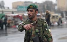 FILE: An Afghan security personnel gestures as he guards the site of an attack in Kabul. Picture: AFP