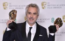 Mexican director Alfonso Cuaron poses with the awards for a Director and for Best Film for 'Roma' at the Bafta British Academy Film Awards at the Royal Albert Hall in London on 10 February 2019. Picture: AFP