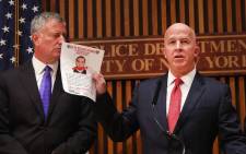 New York City police commissioner James O'Neill holds up a picture of Ahmad Khan Rahami, the man believed to be responsible for the explosion in Manhattan on Saturday night. Picture: Getty Images/AFP.