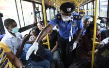 FILE: Lagos Commissioner of Police, Hakeem Odumosu (C), speaks to passengers to enforce social distancing in a bus as part of measures to curb the spread of the COVID-19 coronavirus in Lagos, Nigeria on 27 March 2020. Picture: AFP