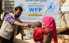 FILE: UN World Food Programme workers hand out food in Syria. Picture: @WFP_Syria/Twitter