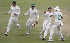 South Africa's Keshav Maharaj (2ndR) celebrates with teammates after the dismissal of England's Ben Stokes during the fourth day of the first Test cricket match between South Africa and England at The SuperSport Park stadium at Centurion near Pretoria on 29 December 2019.
