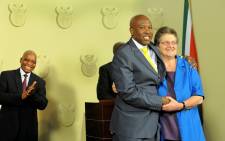 Lesetja Kganyago is congratulated by outgoing SA Reserve Bank governor Gill Marcus (R) after it was announced by President Jacob Zuma (L) that he will become the new SA Reserve Bank governor in Pretoria on Monday, 6 October 2014. Picture: Sapa.