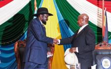 South Sudan’s President Salva Kiir (left) shakes hands with Uganda’s President Yoweri Museveni after signing a peace agreement in August 2015. Picture: AFP.
