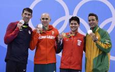 Singapore's Schooling Joseph (2ndR) poses with silver medallists (fromL) USA's Michael Phelps, Hungary's Laszlo Cseh and South Africa's Chad Guy Bertrand Le Clos after he won the Men's 100m Butterfly Final during the swimming event at the Rio 2016 Olympic Games at the Olympic Aquatics Stadium in Rio de Janeiro on 12 August, 2016. Picture: AFP.