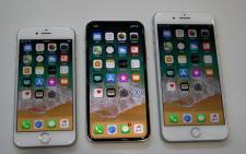 (L-R) The new iPhone 8, iPhone X and iPhone 8S are displayed during an Apple special event at the Steve Jobs Theatre on the Apple Park campus on September 12, 2017 in Cupertino, California. Picture: AFP