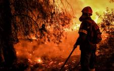 A firefighter is at work to extinguish a wildfire in Skinos, south of Athens, on May 19, 2021. Scores of Greek villagers were evacuated early on May 20, 2021 as a forest fire raged overnight around the protected wildlife habitat of Mount Geraneia, the fire department said, with no injuries immediately reported. Picture: Valerie Gache / AFP