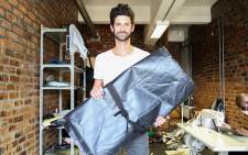 Street Sleeper founder Oliver Brain shows off a bag at his Cape Town workshop. Picture: Leah Rolando
