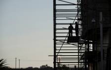 Construction workers on scaffolding at a Johannesburg construction site in May 2015. Picture: AFP.