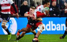 FILE: The Lions' Courtnall Skosan (centre R) is tackled by the Crusaders' Jack Goodhue (centre L) during the Super Rugby final match between the Crusaders and the Lions at AMI Stadium in Christchurch on 4 August, 2018. Picture: AFP
