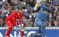 Sri Lanka's Kumar Sangakkara (R) hits a shot watched by England's wicketkeeper Jos Buttler during the 2013 ICC Champions Trophy cricket match between England and Sri Lanka at The Oval cricket ground in London, on June 13, 2013. Picture: AFP.