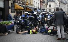 Protesters taking part in an event called "BenallApero", on 1 May, 2019, prevent police from accessing the Contrescarpe square in Paris, a site where a former Elysee senior security officer had been caught on video hitting a protester during a May Day rally. Picture: AFP