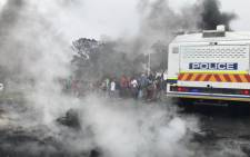A group of Ocean View protesters are seen next to a police van during a demonstration against gang violence. Picture: Kevin Brandt/EWN