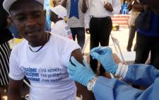 A World Health Organization worker administers a vaccination during the launch of a campaign aimed at beating an outbreak of Ebola in the port city of Mbandaka, Democratic Republic of Congo, on 21 May 2018. Picture: Reuters